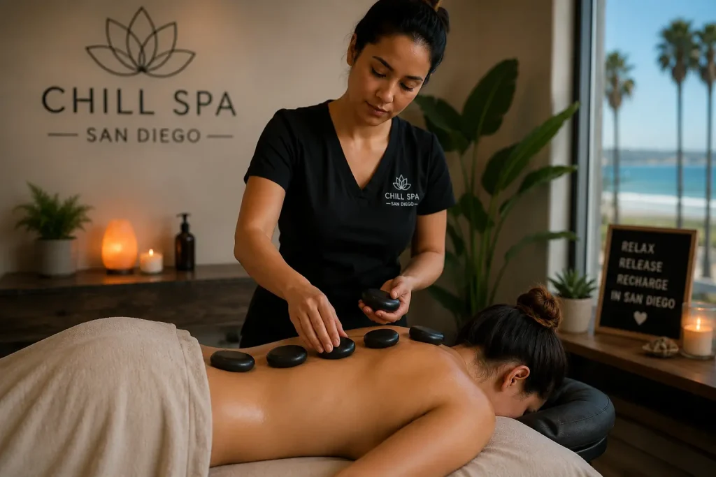 Spa therapist placing hot stones on a client’s back during a relaxing hot stone massage session at Chill Spa in San Diego.